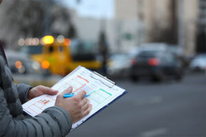 Driver filling out a report after being involved in a car accident