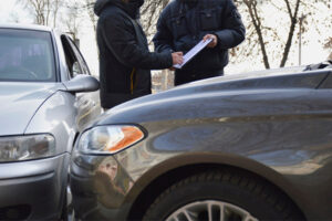 Officer filing a police report at an accident scene