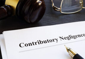 Document describing contributory negligence on a lawyer's desk