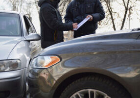 Officer filing a police report at an accident scene
